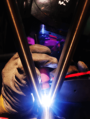 Framebuilder welding a bike frame