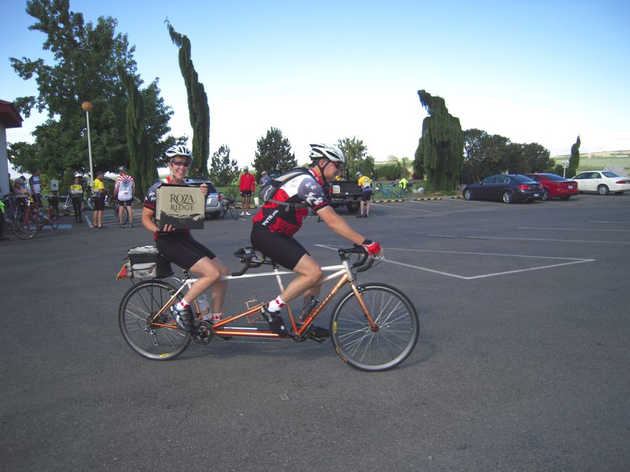 Mike and Carol riding their Tandem, protecting their wine purchase